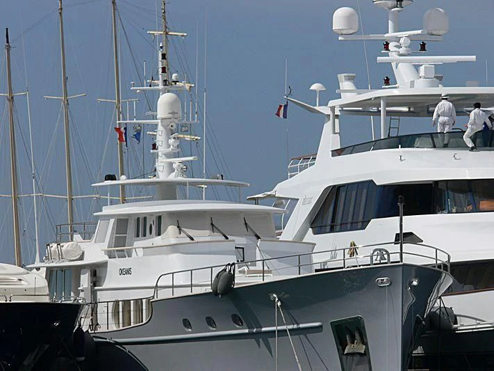 a couple of boats are parked in a harbor aboard OKEANIS Yacht for Sale