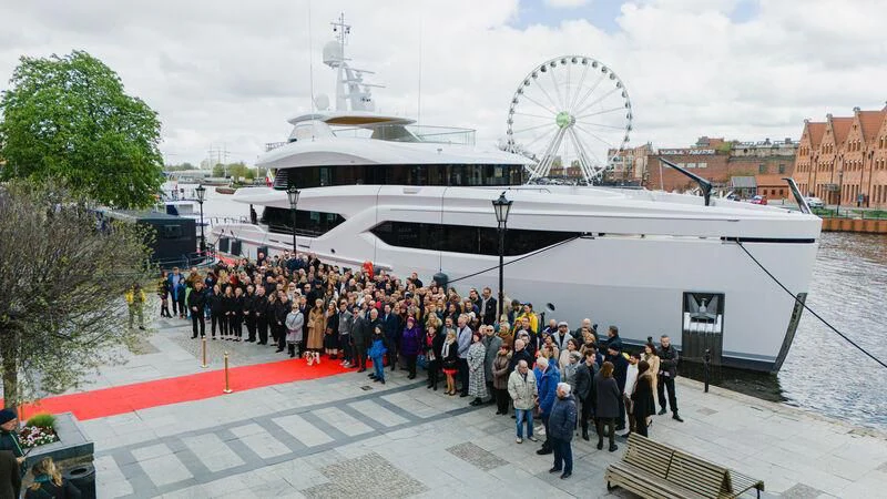 a large crowd of people standing next to a large white boat aboard EXTRA TIME Yacht for Sale