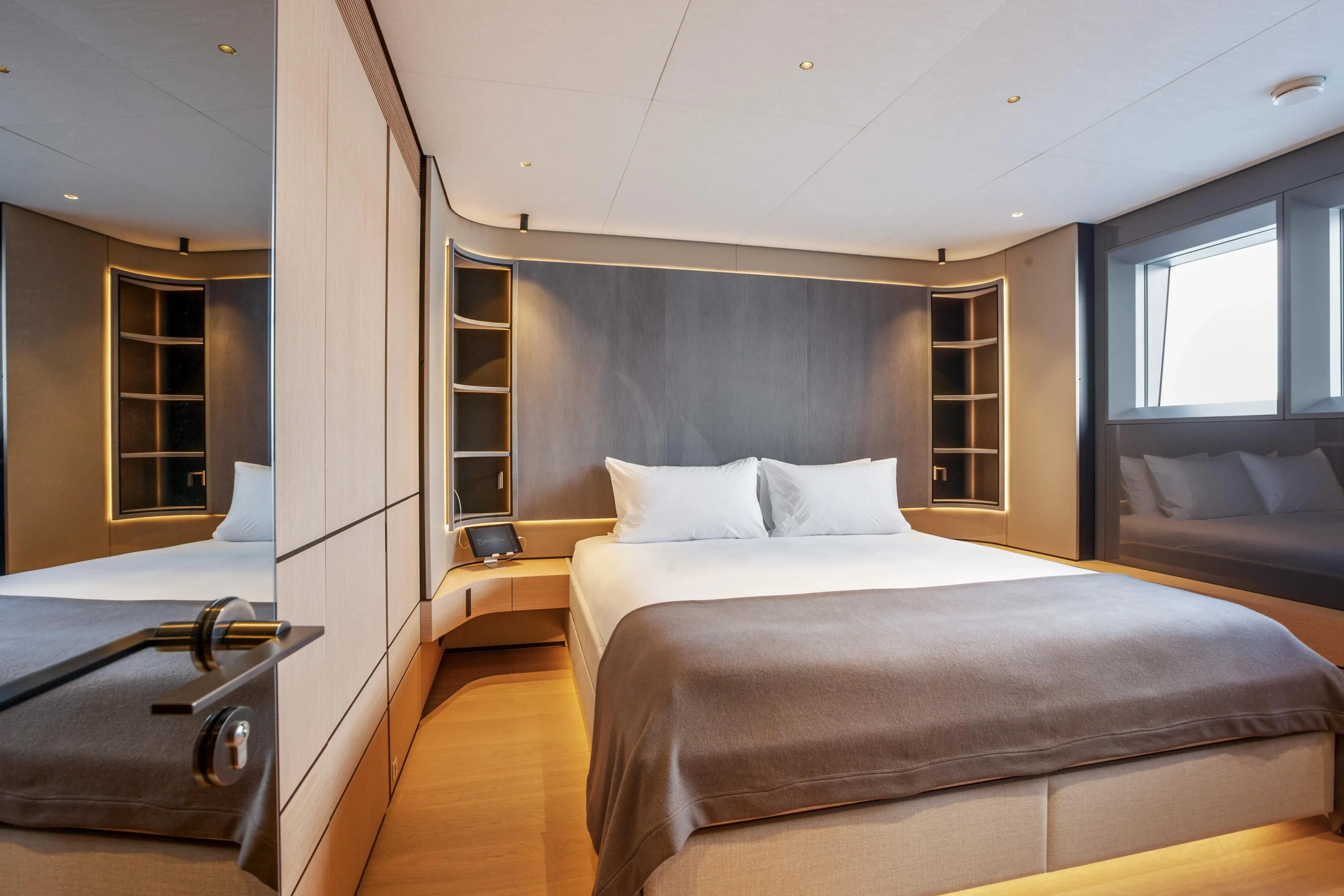 a room with a bed and a couch aboard EXTRA TIME Yacht for Sale