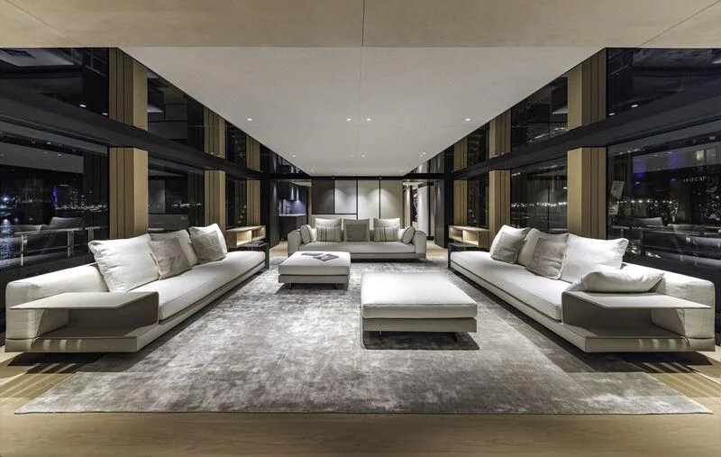 a modern living room with white furniture aboard EXTRA TIME Yacht for Sale