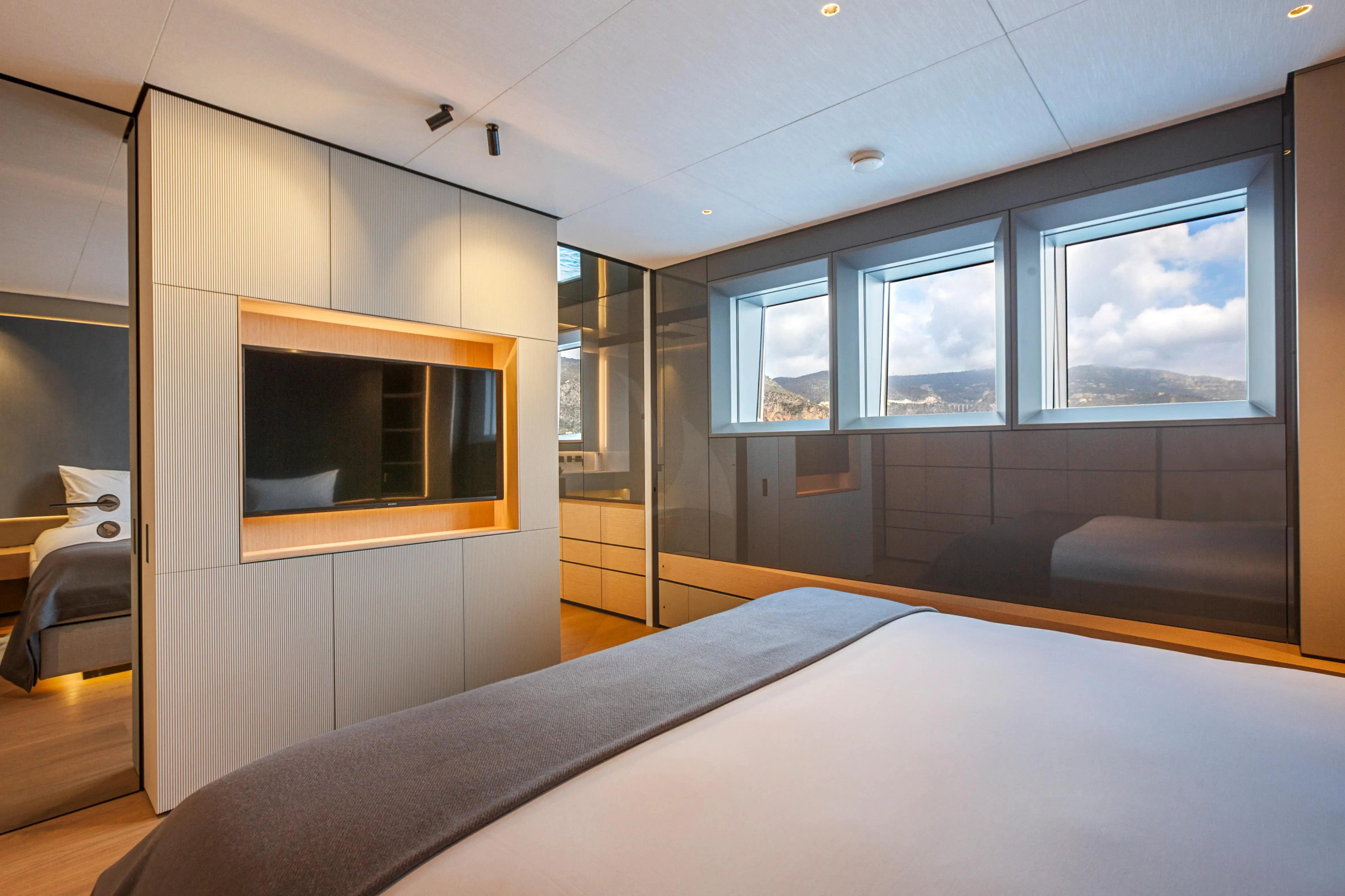 a room with a bed and a window aboard EXTRA TIME Yacht for Sale