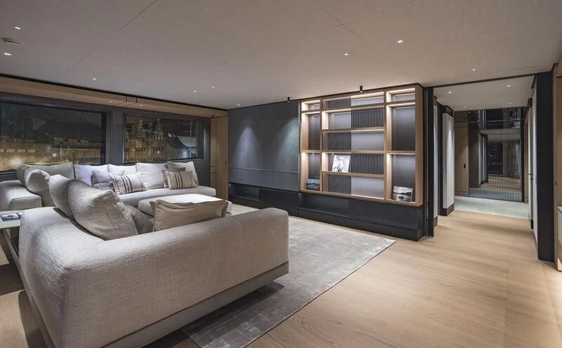 a large living room with a large glass wall aboard EXTRA TIME Yacht for Sale