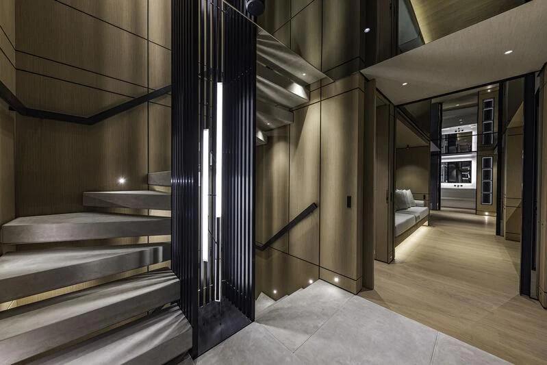 a large room with a staircase aboard EXTRA TIME Yacht for Sale