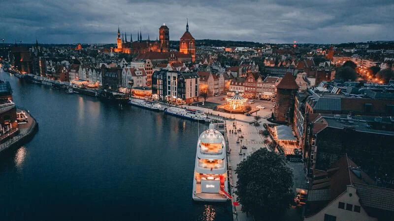 a city with a river and boats aboard EXTRA TIME Yacht for Sale