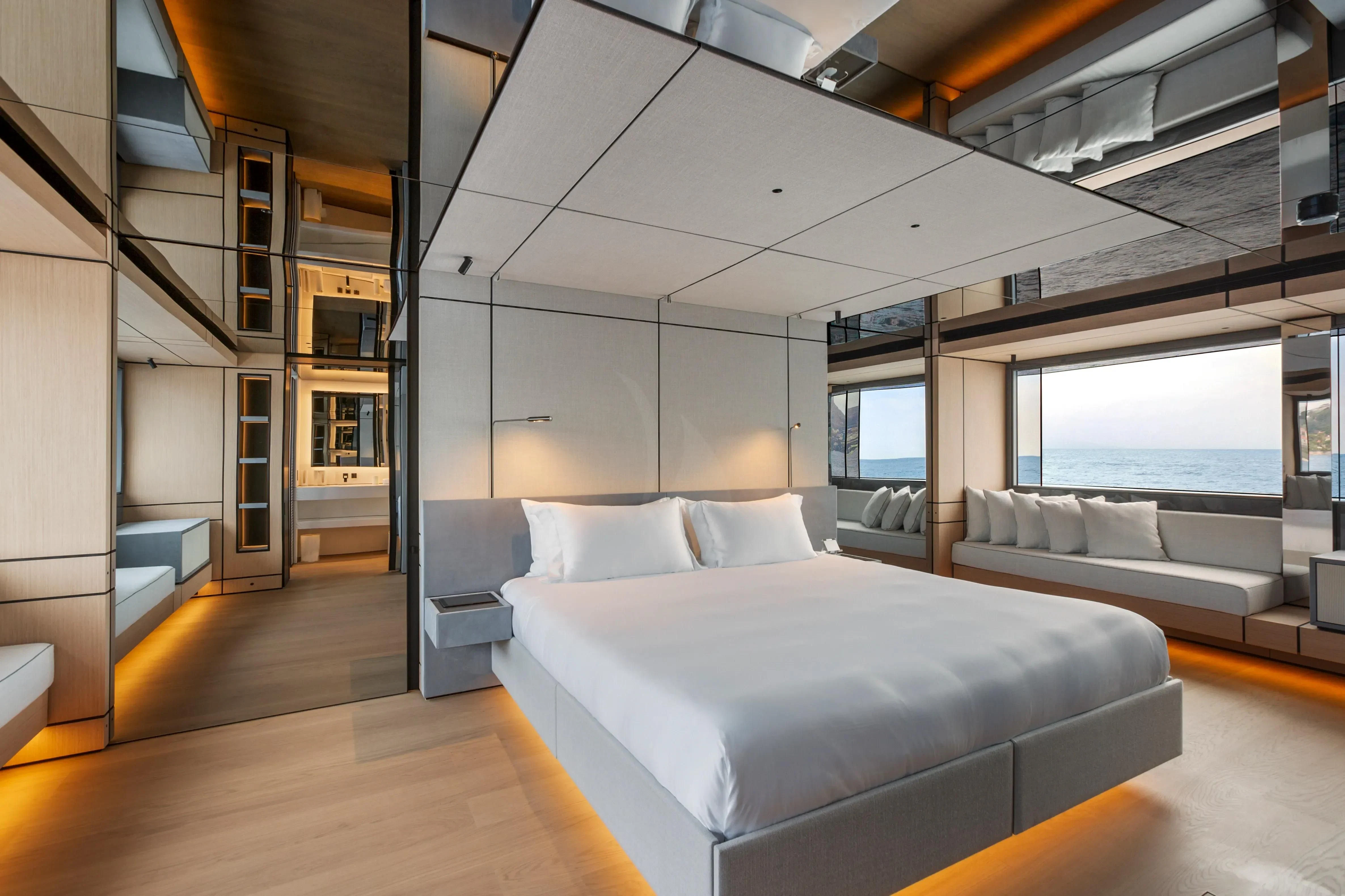 a room with a bed and a large window aboard EXTRA TIME Yacht for Sale
