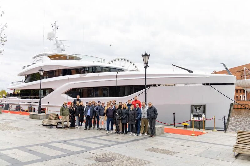 a group of people standing outside a cruise ship aboard EXTRA TIME Yacht for Sale