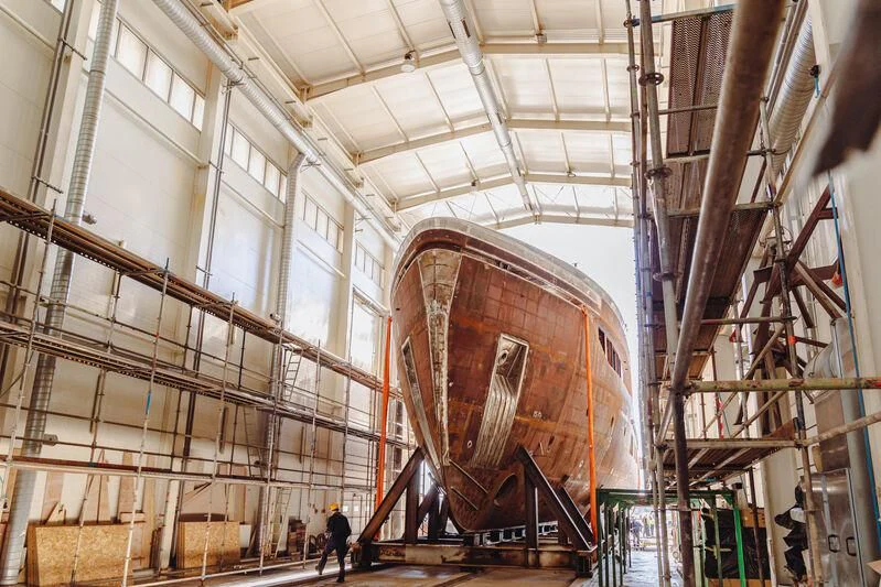 a large room with a few people aboard EXTRA TIME Yacht for Sale