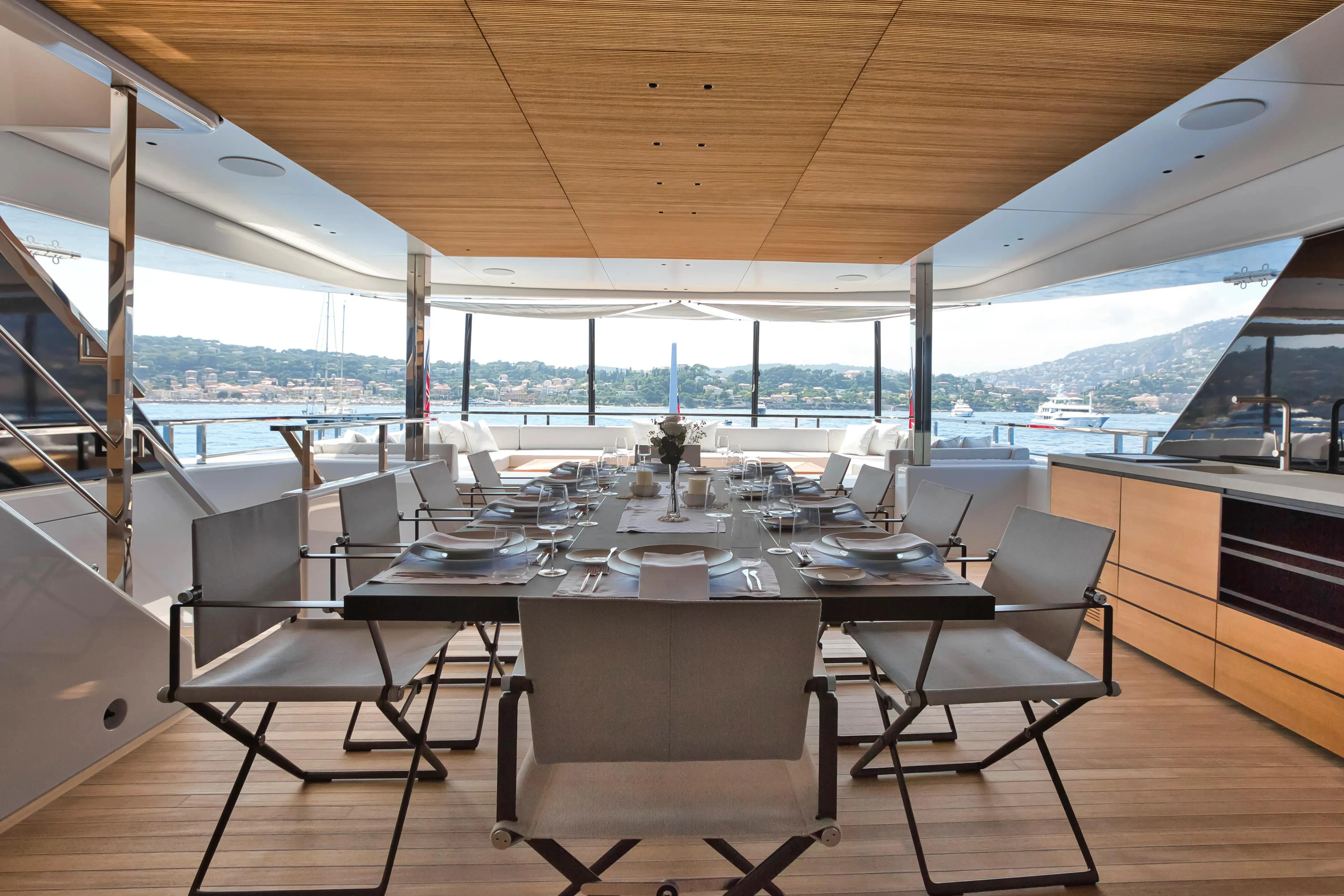 a room with a table and chairs aboard EXTRA TIME Yacht for Sale