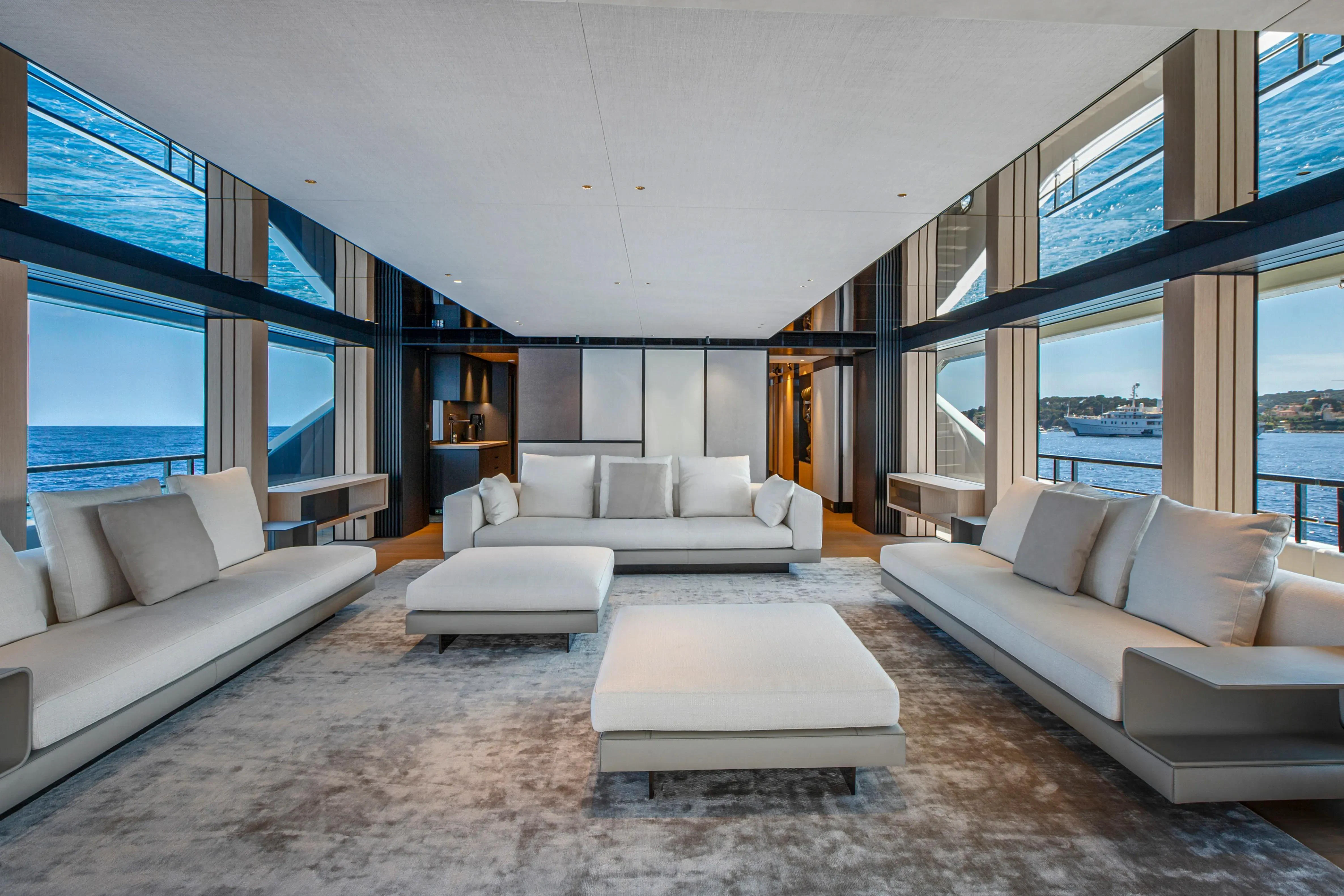 a living room with white couches aboard EXTRA TIME Yacht for Sale