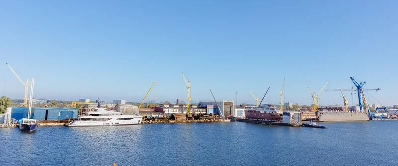 a body of water with cranes and boats on it aboard EXTRA TIME Yacht for Sale