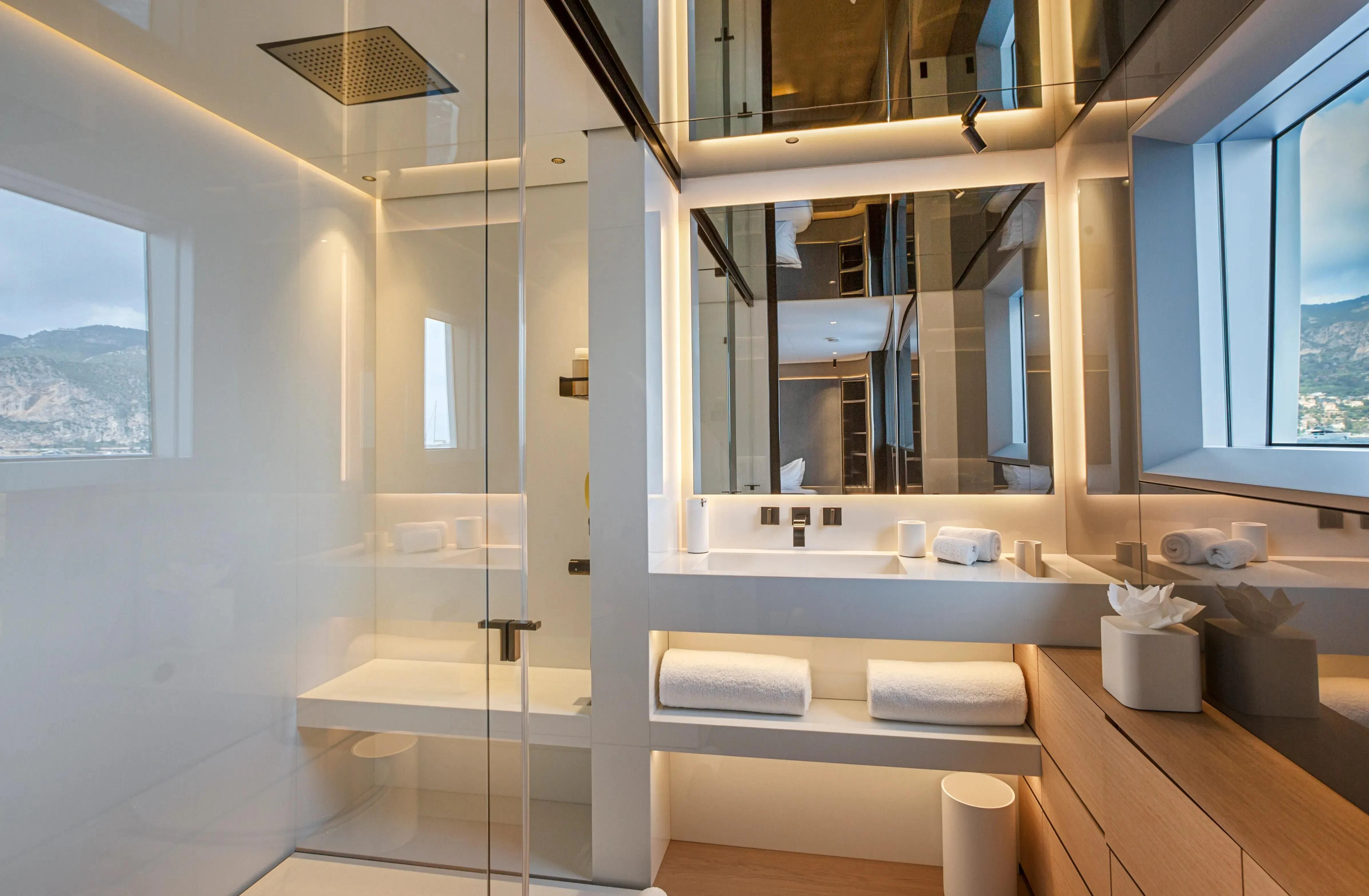 a bathroom with a glass shower aboard EXTRA TIME Yacht for Sale