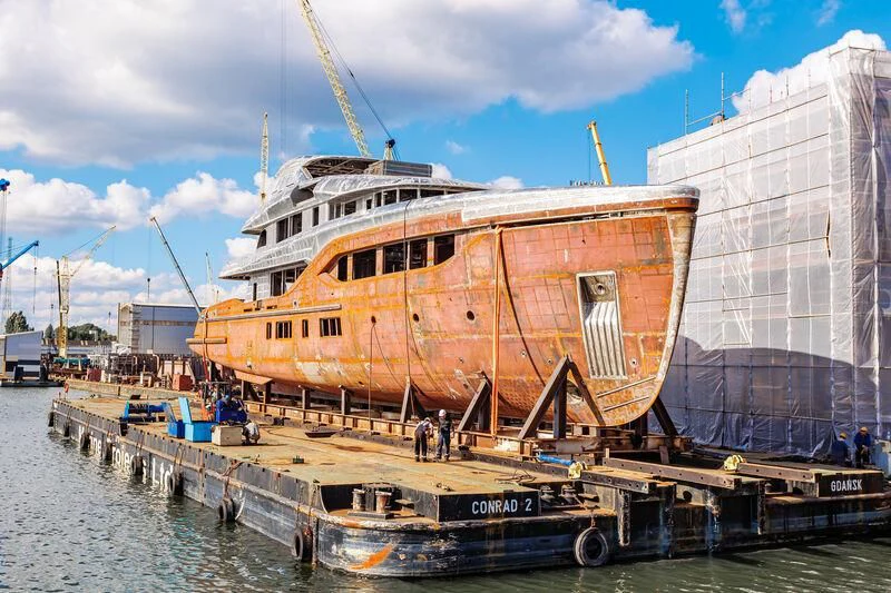 a large ship docked aboard EXTRA TIME Yacht for Sale