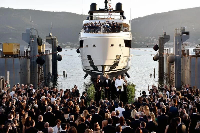 a large crowd of people standing next to a large ship aboard CONTIGO Yacht for Sale