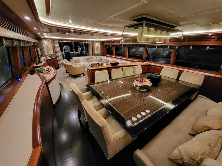 a living room with a table and couches aboard EAGLE WINGS 3 Yacht for Sale