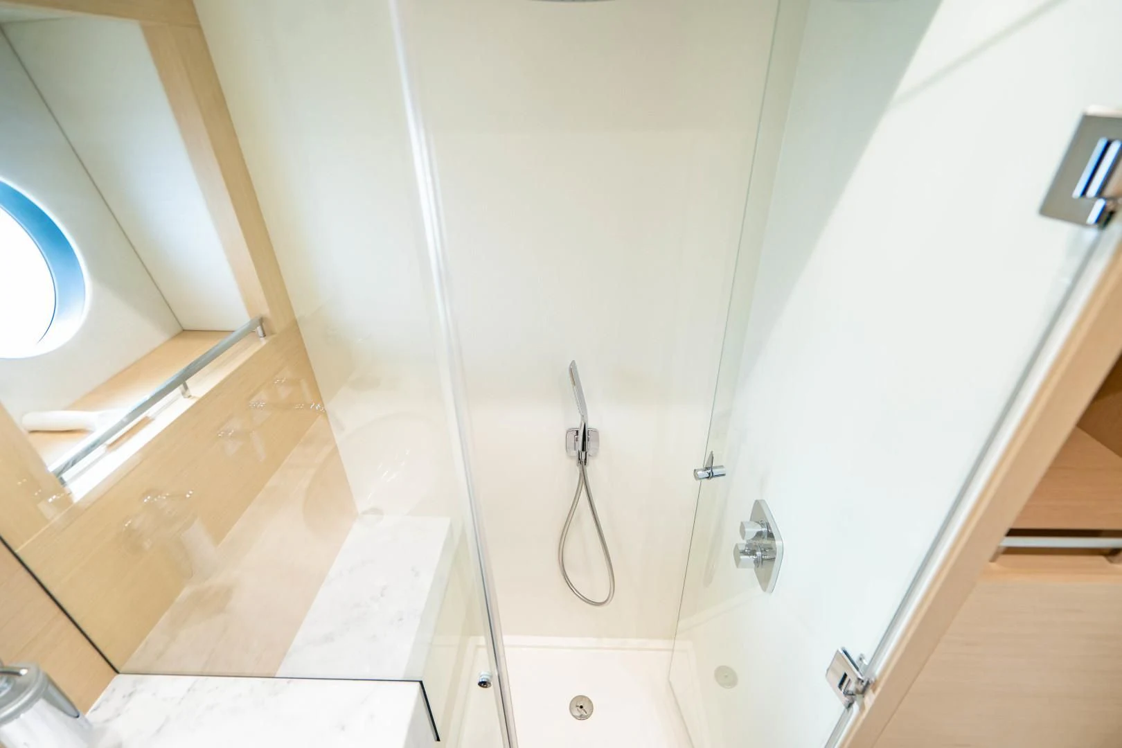 a white bathroom with a glass door aboard SUBMARINO Yacht for Sale