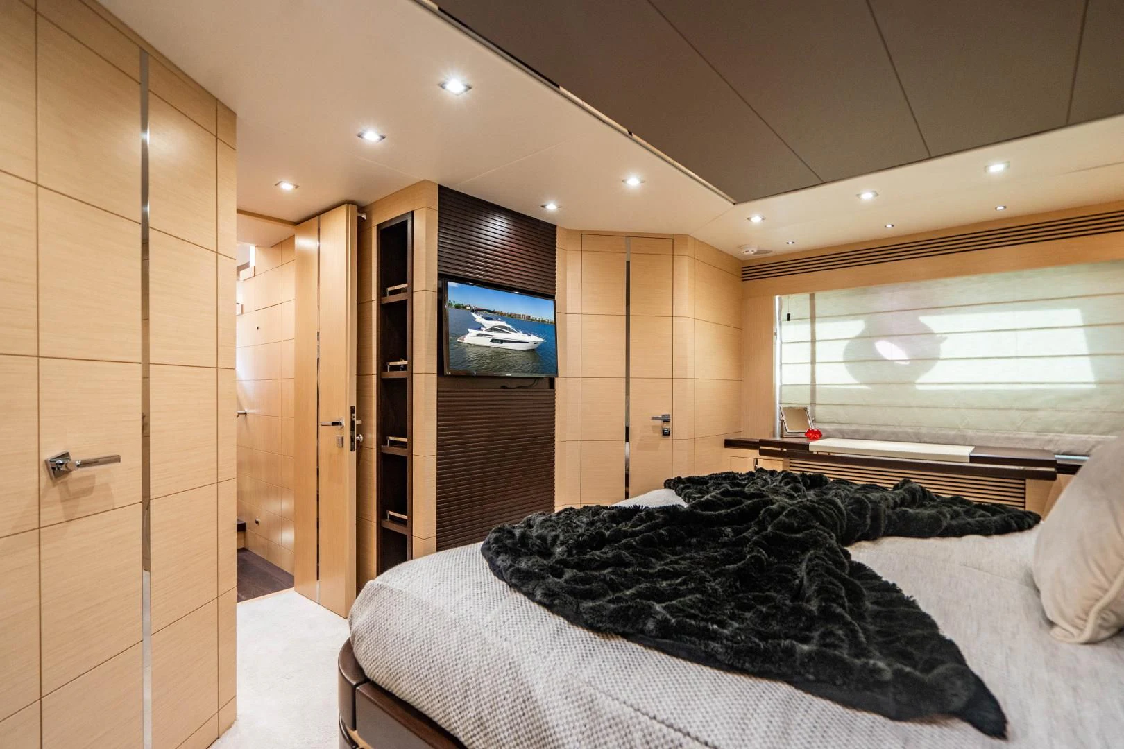 a bedroom with a bed and a tv aboard SUBMARINO Yacht for Sale