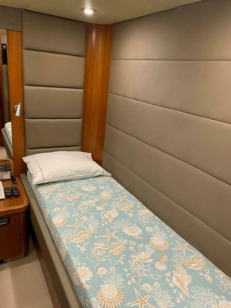 a bed with a blue comforter aboard JULCAN II Yacht for Sale