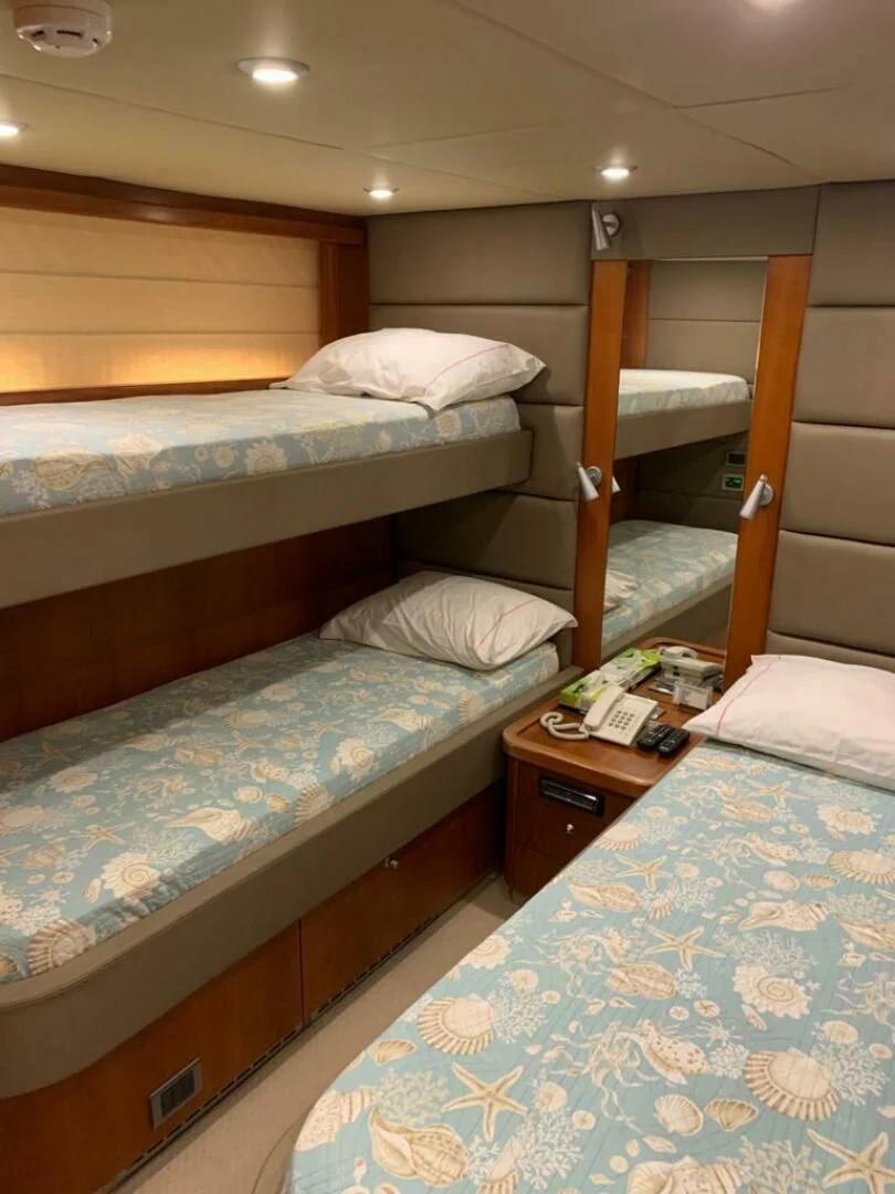 a couple of beds in a hotel room aboard JULCAN II Yacht for Sale