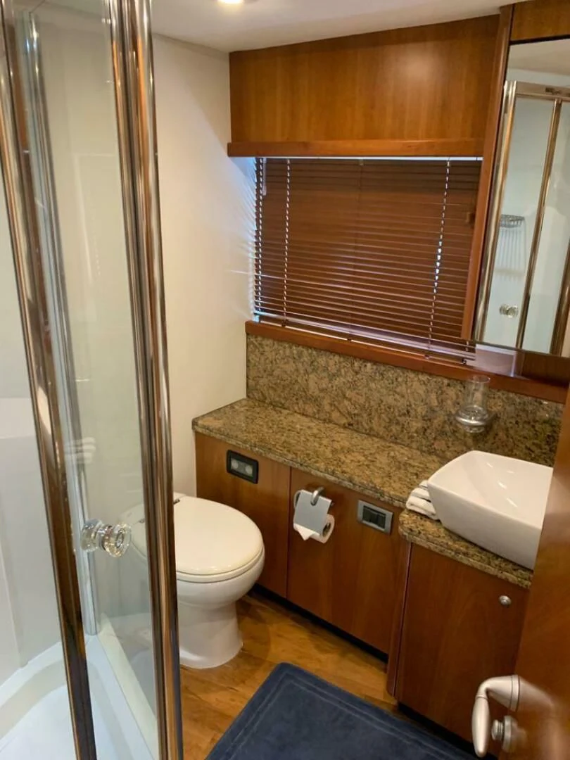 a bathroom with a sink toilet and a mirror aboard JULCAN II Yacht for Sale