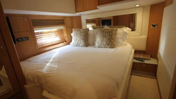 a bed with white sheets aboard BST SUNRISE Yacht for Sale