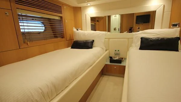 a room with beds and a window aboard BST SUNRISE Yacht for Sale