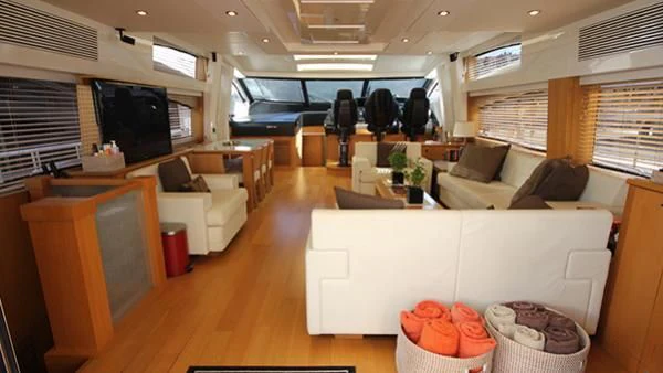 a living room with a couch and a tv aboard BST SUNRISE Yacht for Sale