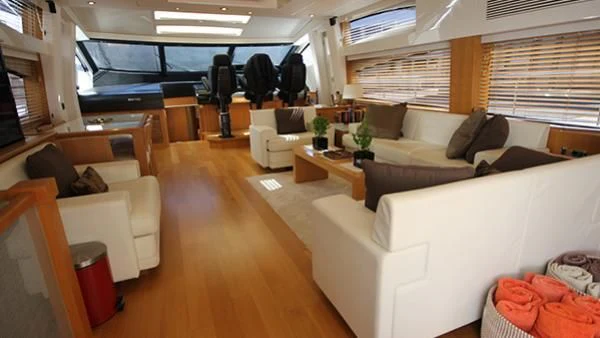 a living room with a couch and a table aboard BST SUNRISE Yacht for Sale