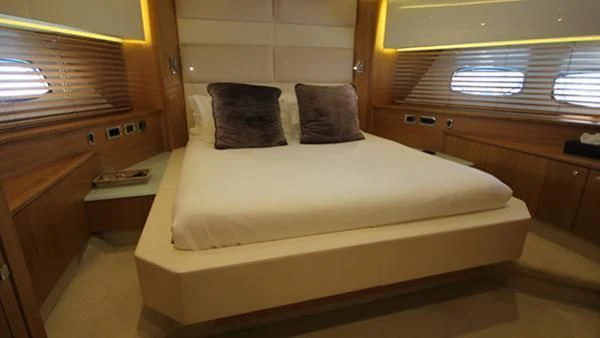 a bed with a white sheet aboard BST SUNRISE Yacht for Sale