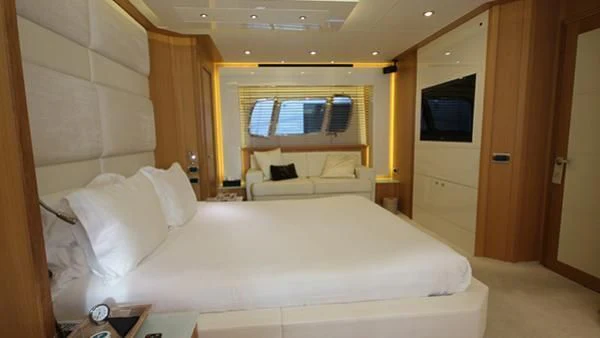a room with a bed and a television aboard BST SUNRISE Yacht for Sale