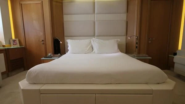 a bed with white sheets aboard BST SUNRISE Yacht for Sale