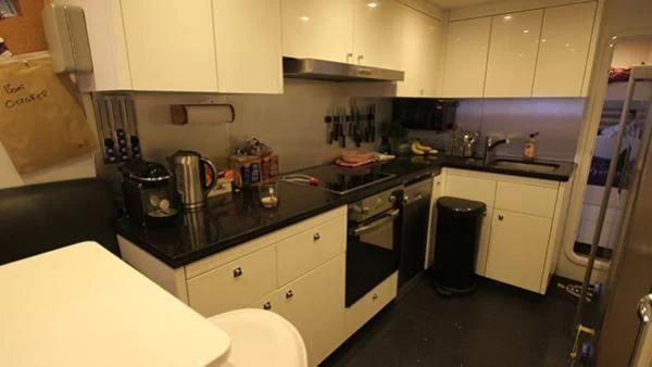 a kitchen with white cabinets aboard BST SUNRISE Yacht for Sale
