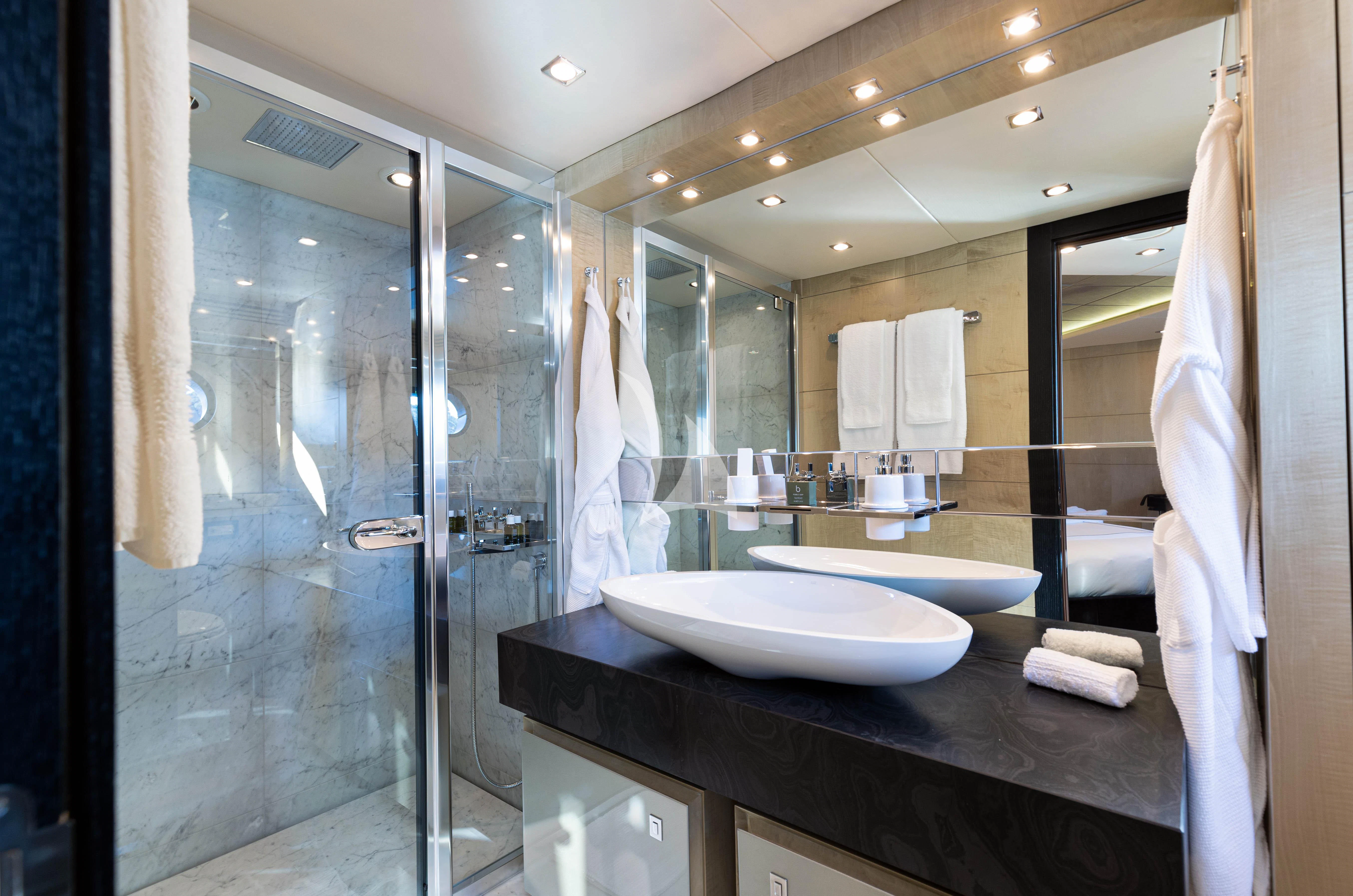 a bathroom with a large glass shower aboard OKSANCHIK Yacht for Charter