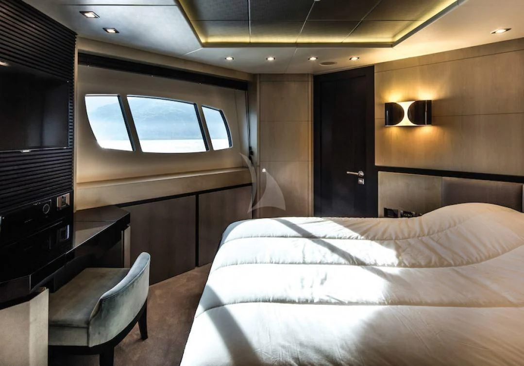 a room with a bed and a television aboard OKSANCHIK Yacht for Charter
