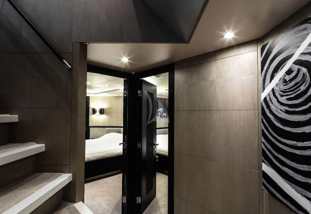 a room with a bed and a mirror aboard OKSANCHIK Yacht for Charter
