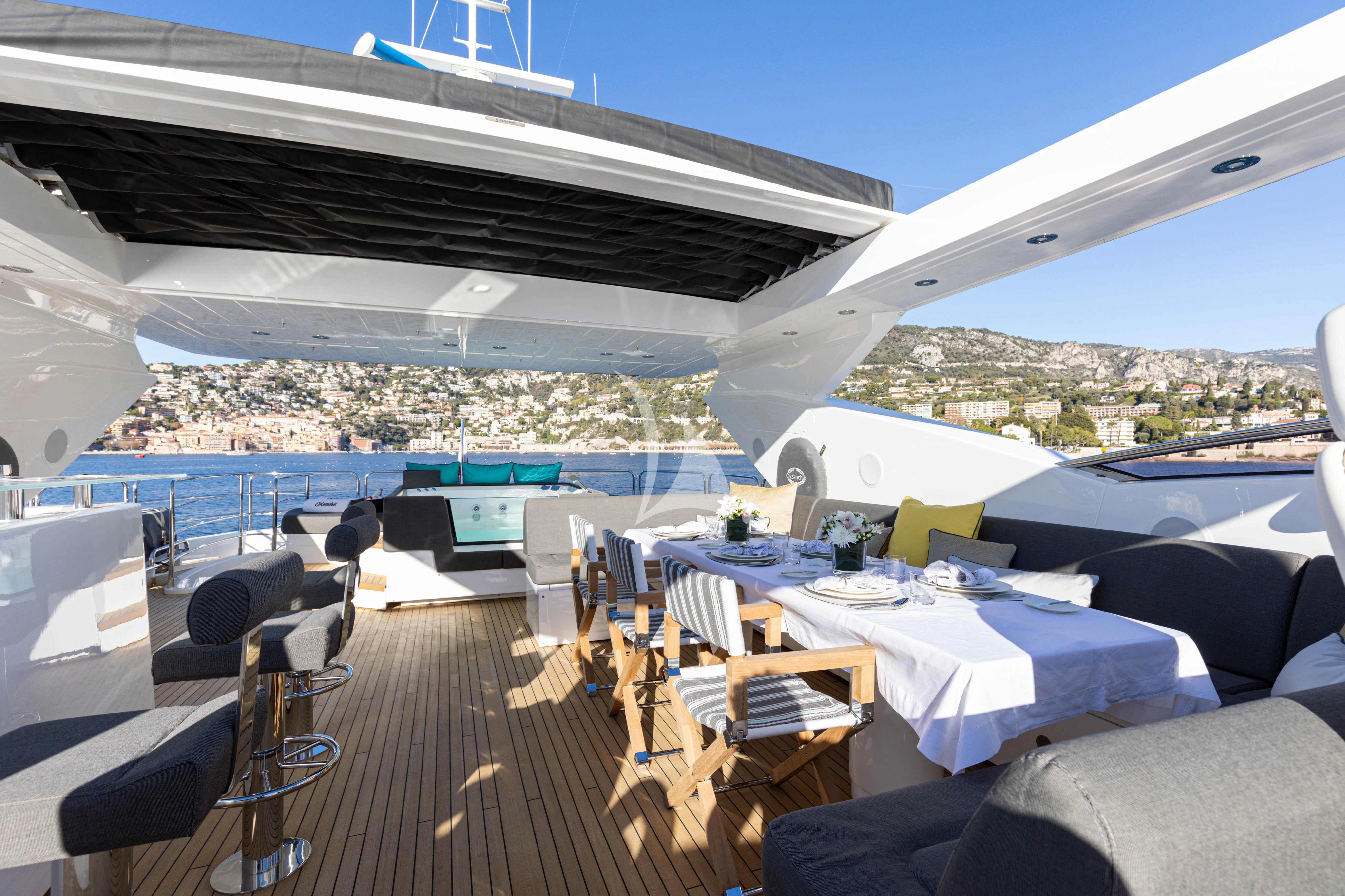a large patio with tables and chairs aboard OKSANCHIK Yacht for Charter