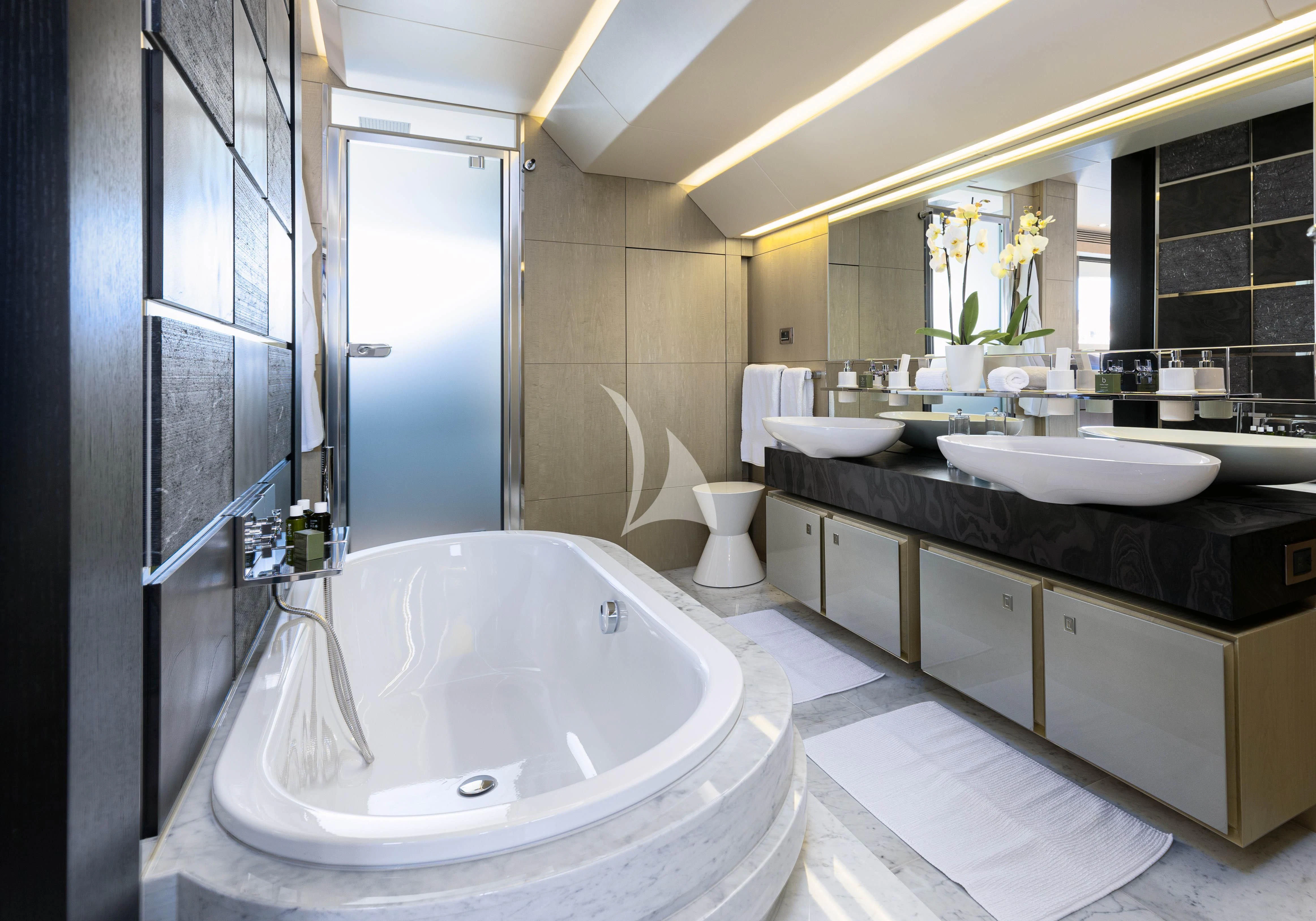 a bathroom with a tub sink and a mirror aboard OKSANCHIK Yacht for Charter