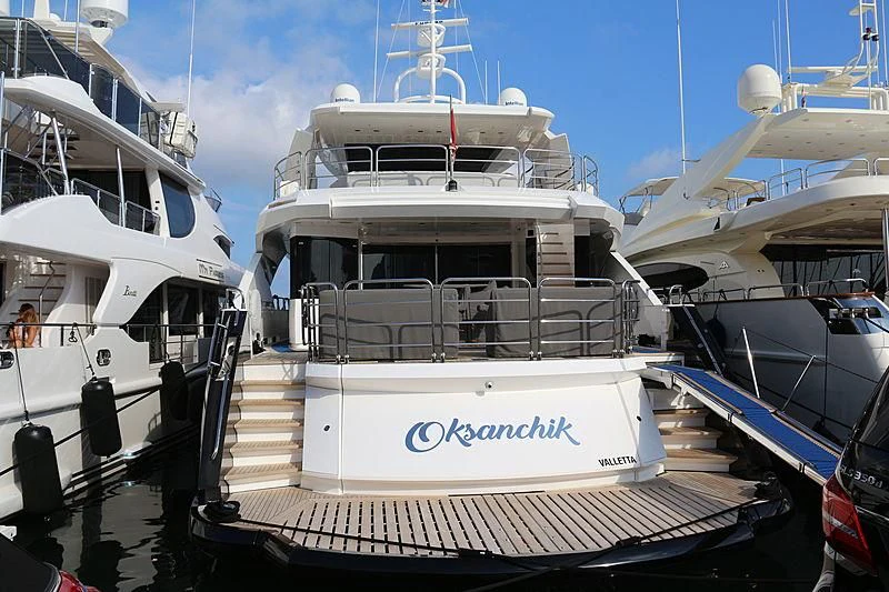 a boat docked at a pier aboard OKSANCHIK Yacht for Charter