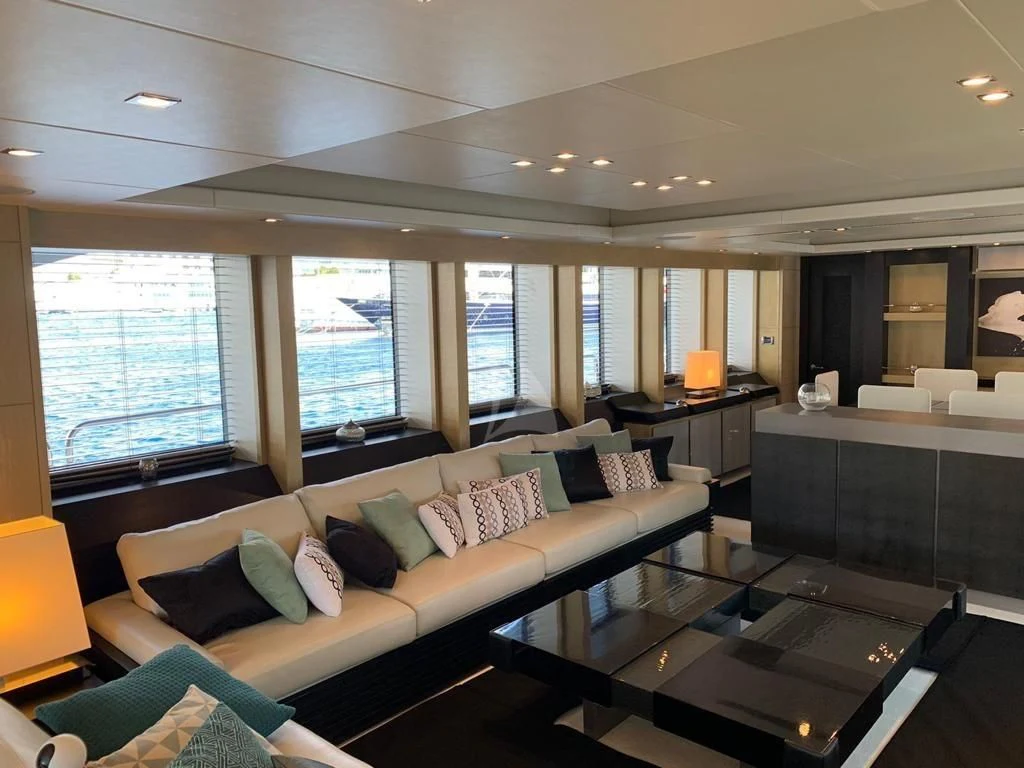a living room with a large window aboard OKSANCHIK Yacht for Charter