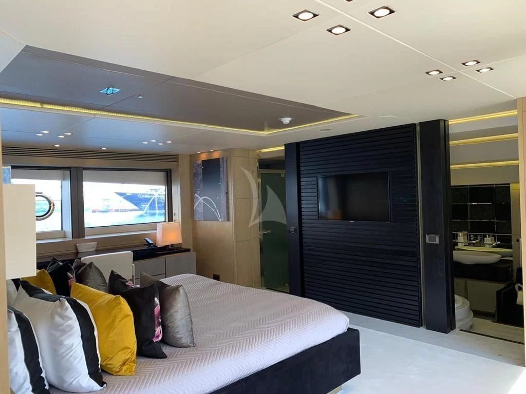 a bedroom with a bed and a tv aboard OKSANCHIK Yacht for Charter