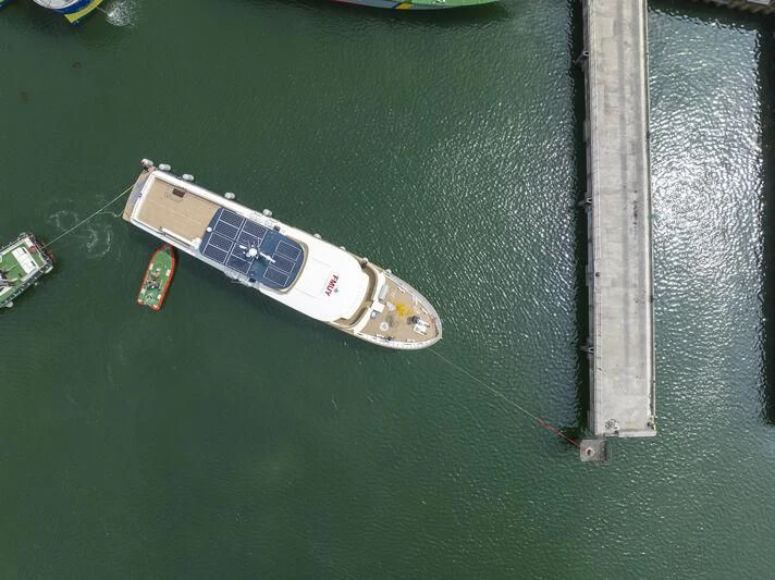 a small white and blue guitar on a green surface aboard ARAOK II Yacht for Sale