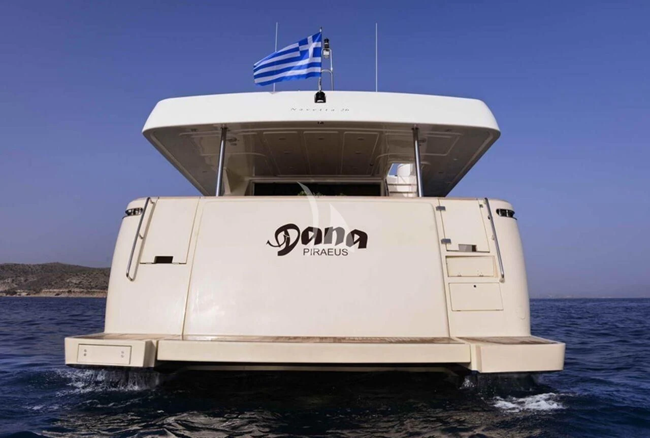 a white boat with a flag on it aboard DANA Yacht for Sale