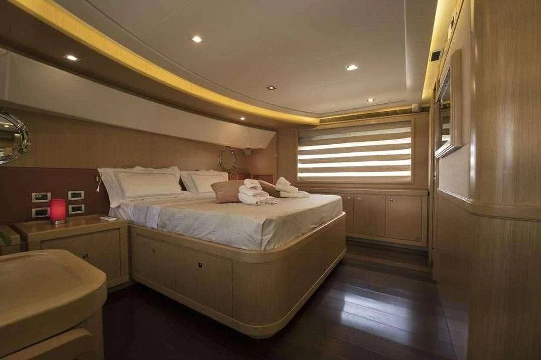 a room with a bed and a window aboard DANA Yacht for Sale