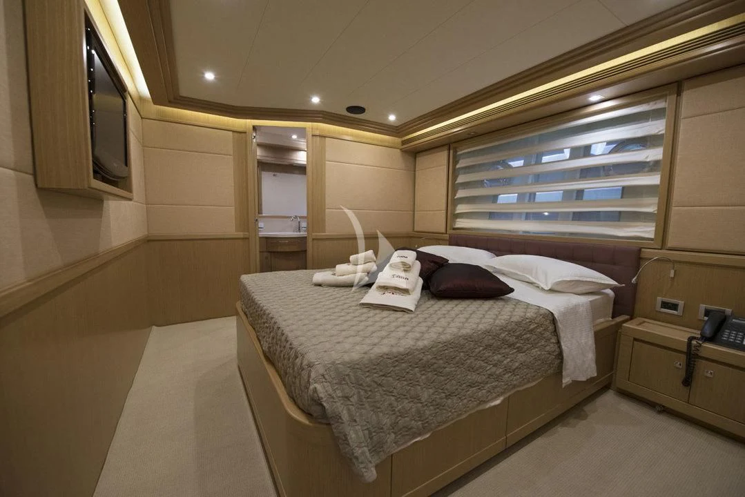 a room with a bed and a mirror aboard DANA Yacht for Sale