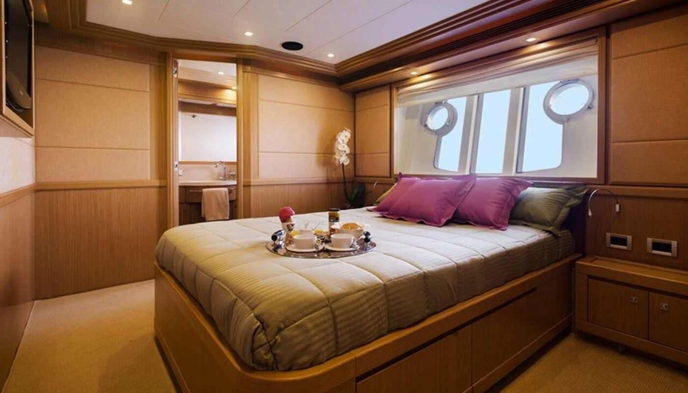 a bed with a tray on it aboard DANA Yacht for Sale