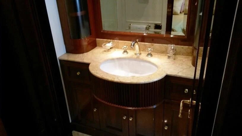 a bathroom sink with a mirror above it aboard SATINE Yacht for Sale