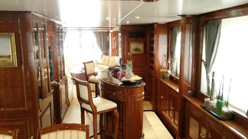 a room with a table chairs and a window aboard SATINE Yacht for Sale