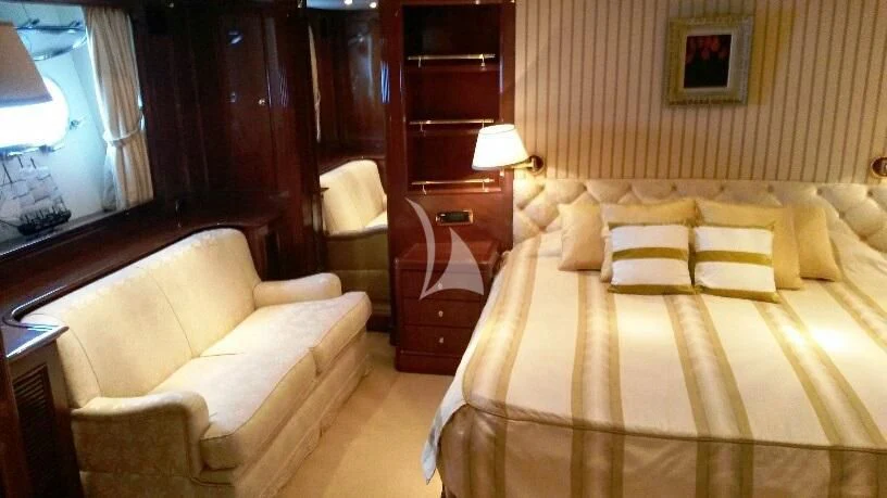 a room with a bed and a couch aboard SATINE Yacht for Sale