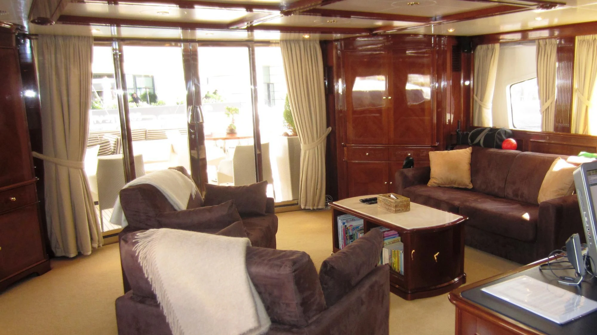 a living room with couches and a coffee table aboard SATINE Yacht for Sale
