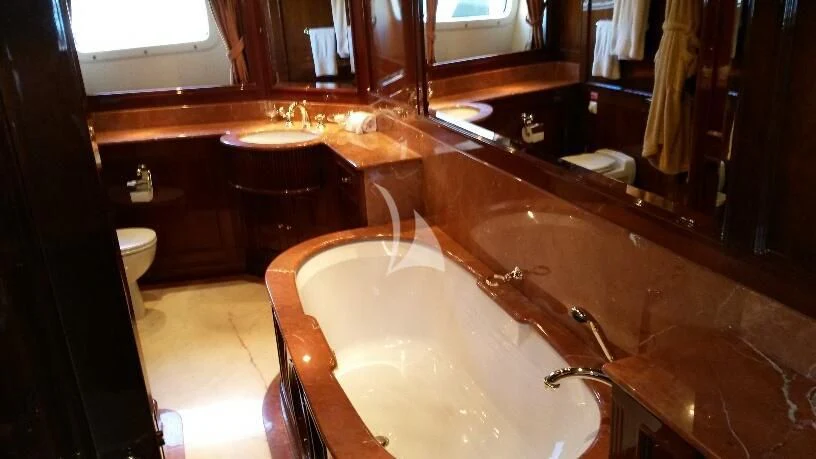 a bathroom with a bathtub and sinks aboard SATINE Yacht for Sale