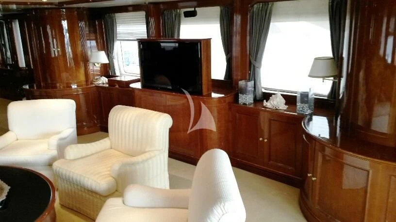 a living room with a tv and furniture aboard SATINE Yacht for Sale